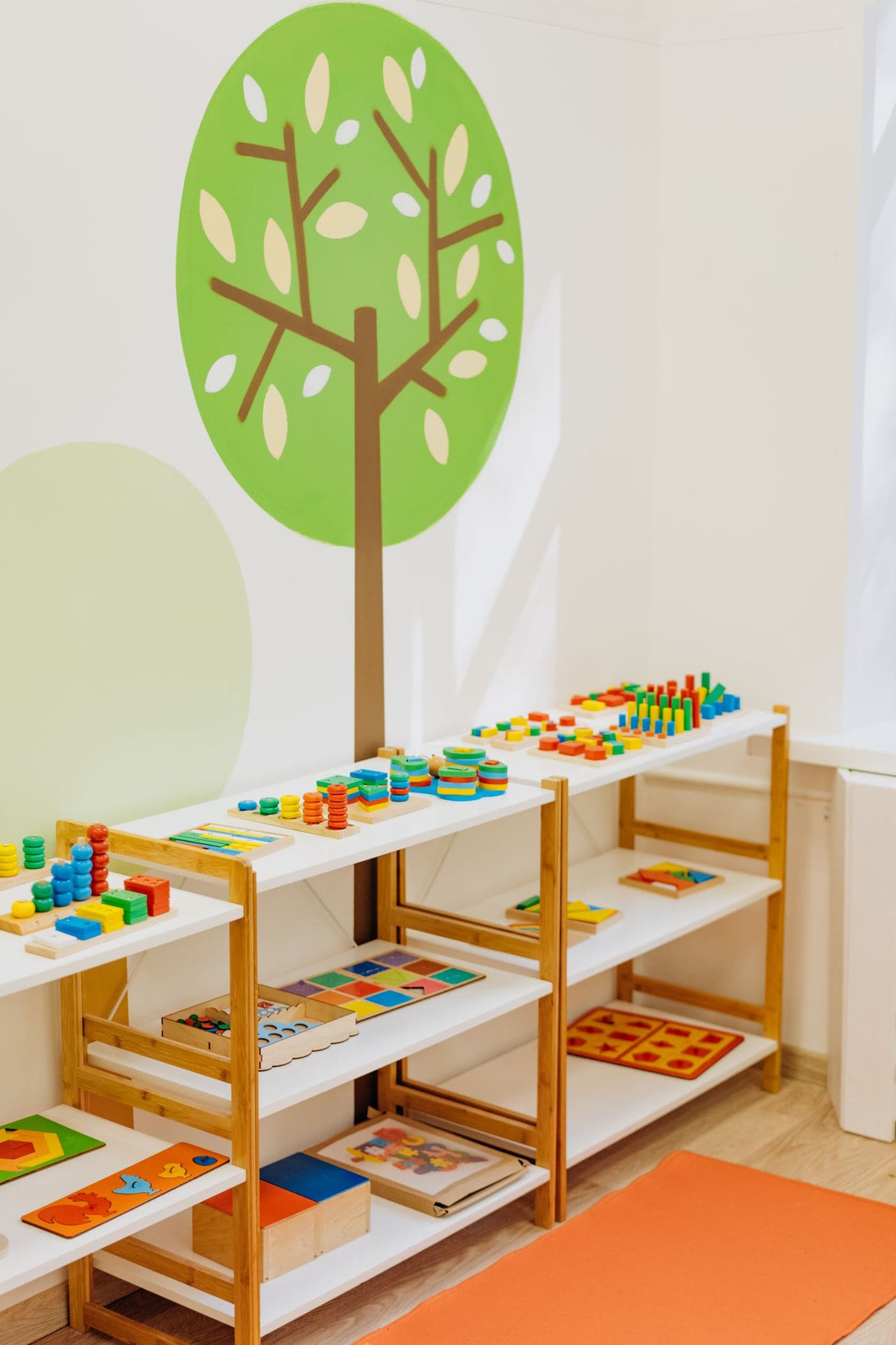 Wooden shelves of sorted learning materials in a bright classroom